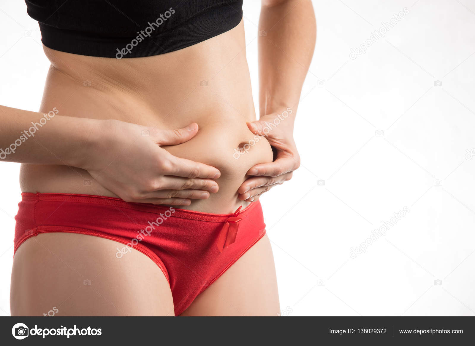 The girl in a red underwear to touch the fat on your stomach and Stock  Photo by ©Vox19 138029372