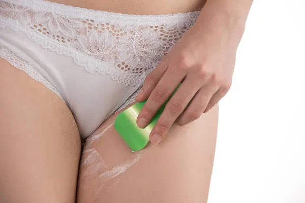 A girl in panties shaves her hair in the bikini area with a razo — Stock Image A girl in panties shaves her hair in the bikini area with a razo Stock Picture