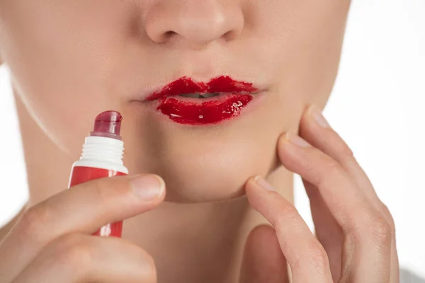 A beautiful young girl applies a persistent liquid red lipstick — Stock Photo, Image