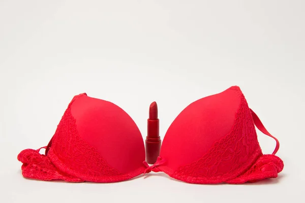 Red bra and matt lipstick on white background — Stock Photo, Image