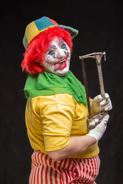 Evil scary clown with red hair on a black background