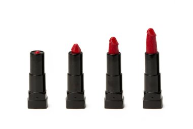 Beautiful red lipstick in the form of a penis is twisted in a fe