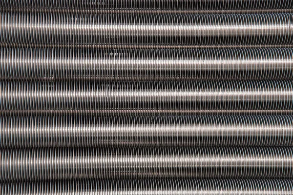 Abstract background of metallic long pipes with thread — Stock Photo, Image