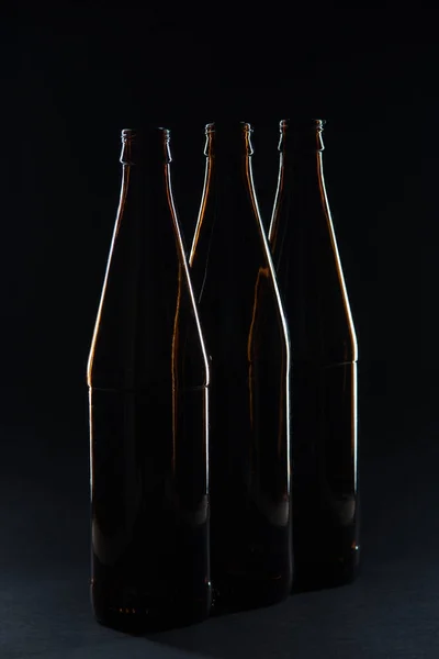 Silhouettes glass bottles for beer on a black background — Stock Photo, Image