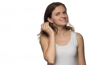 Genç güzel esmer kız temizler kulakları çubuklarla wi