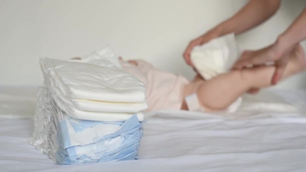 Young Mother Changes Her Baby White Clean Diaper Home Bed — Stock Video