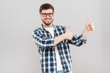 Young man showing thumbs-up aside