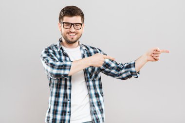 Young man pointing aside