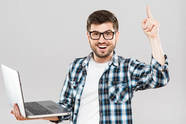 Smiling man in glasses with laptop has idea — Stock Photo, Image