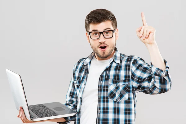 Young man in glasses with laptop has idea — Stockfoto