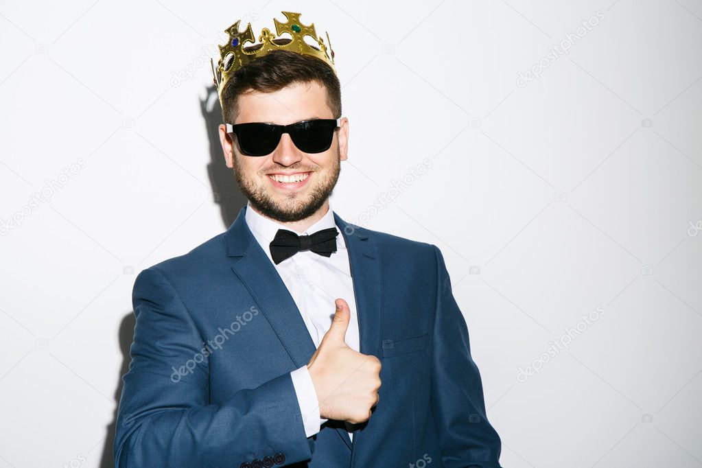 Man in crown showing thumbs-up