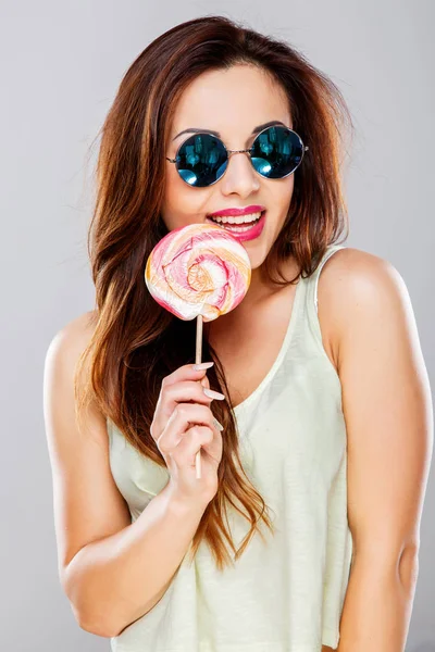 Hermosa chica con grandes dulces de colores — Foto de Stock