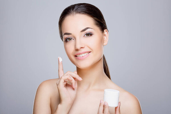 Beautiful girl holding cream