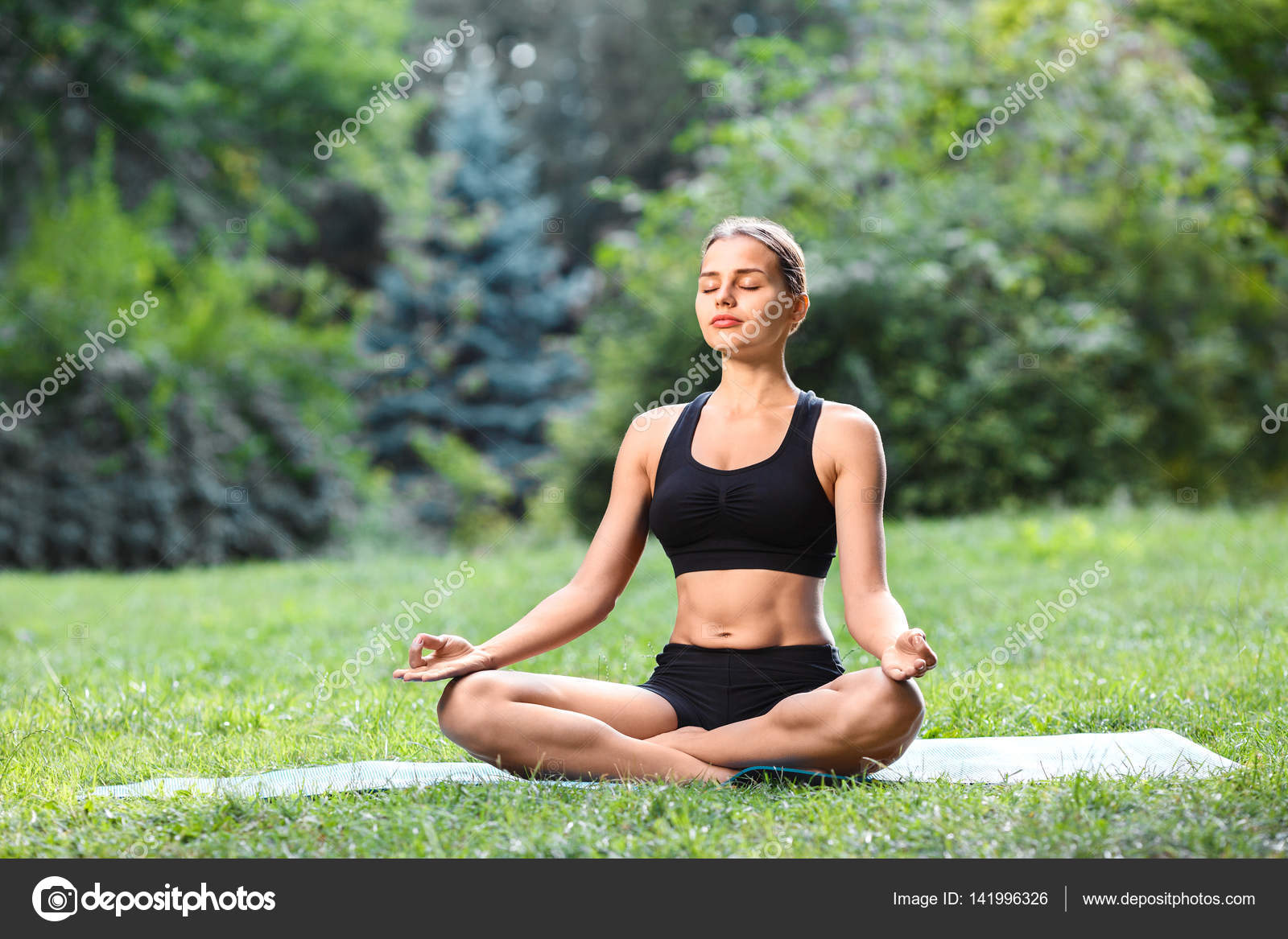 Woman practicing yoga outdoors Stock Photo by ©VelesStudio 141996326