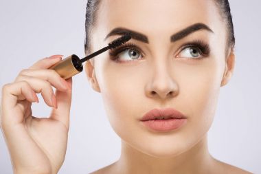  kız makyaj maskara ile yapıyor