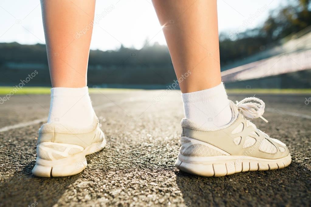girl in white sneakers and socks standing