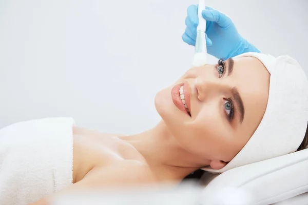 Beautiful young woman during cosmetic procedure