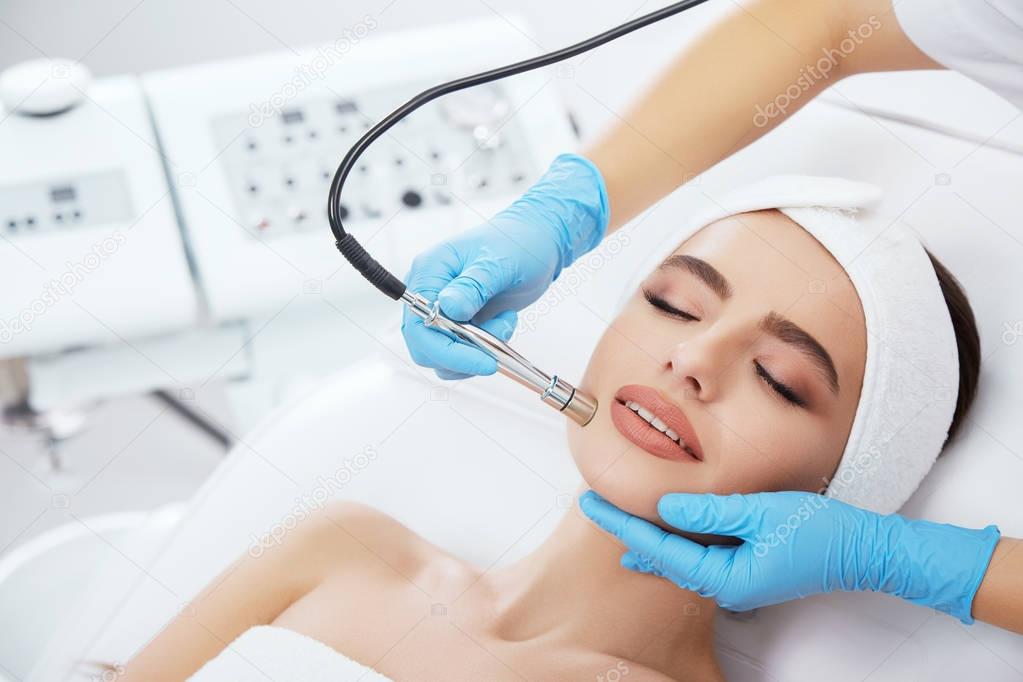 Young woman doing cosmetic procedure