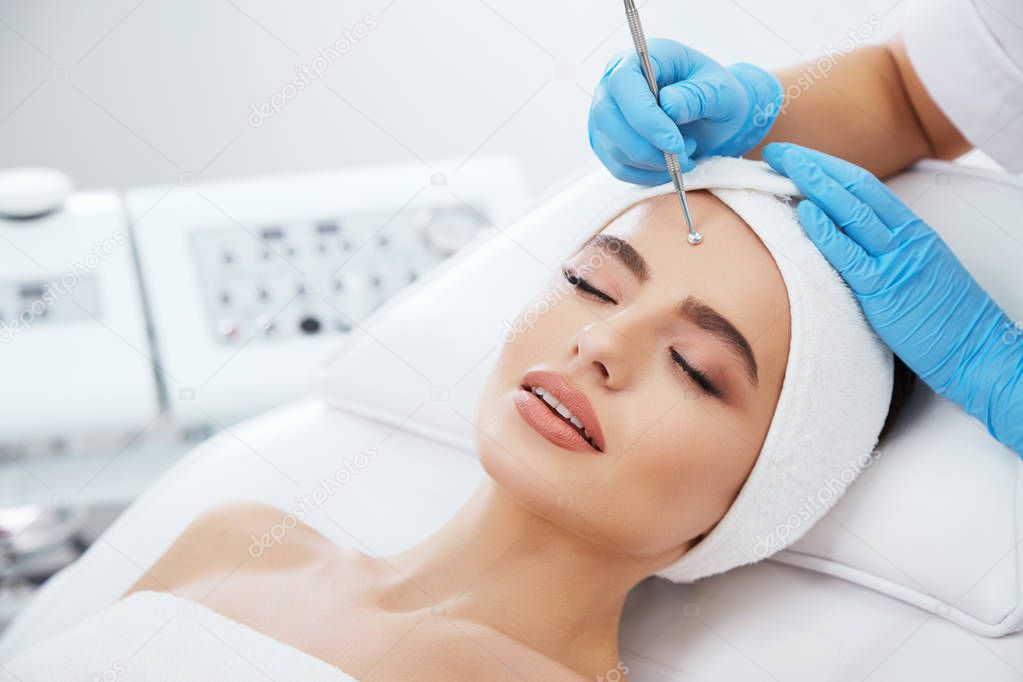 Beautiful young woman during cosmetic procedure 