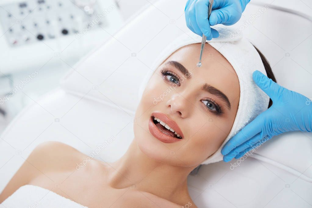 Beautiful young woman during cosmetic procedure 