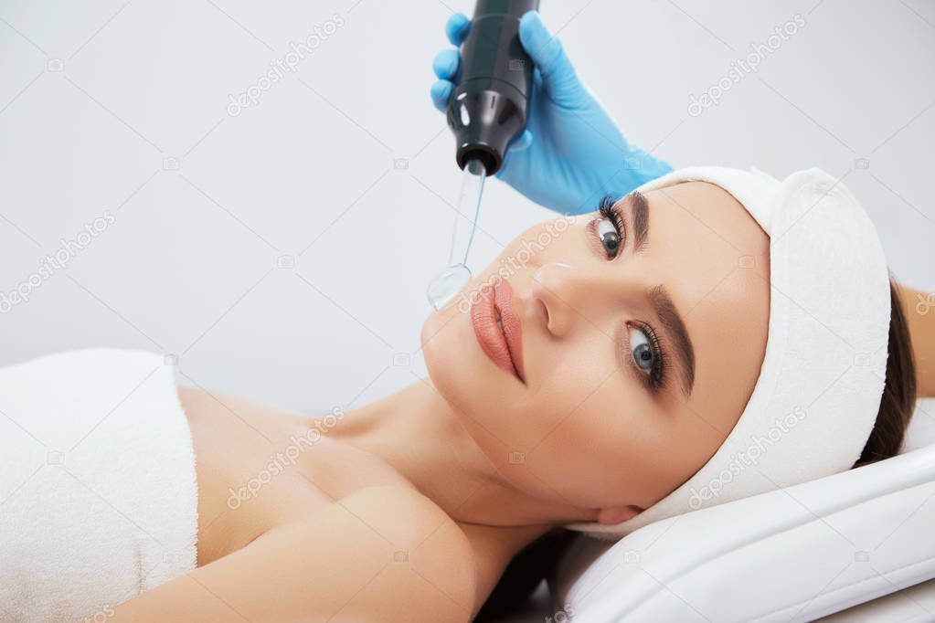 beautiful young woman during cosmetic procedure