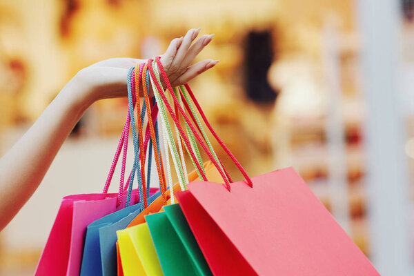 woman holding colorful shopping bags