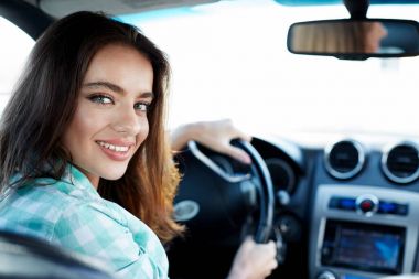 Cute woman in new automobile  clipart