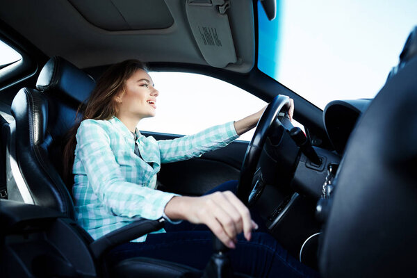 Exited woman in new automobile 