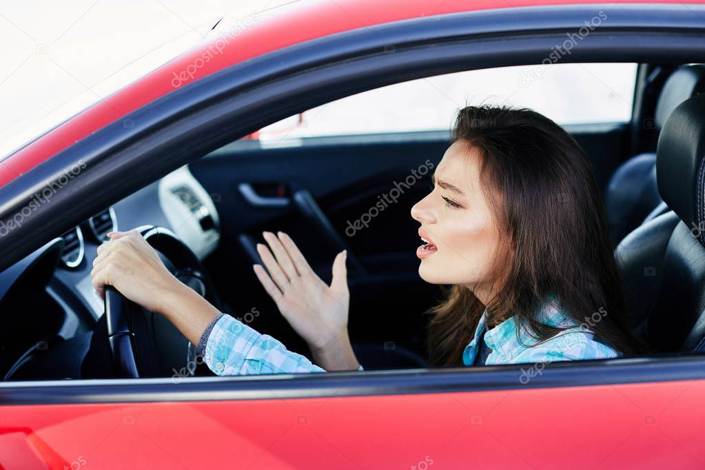 stressed woman driving red car