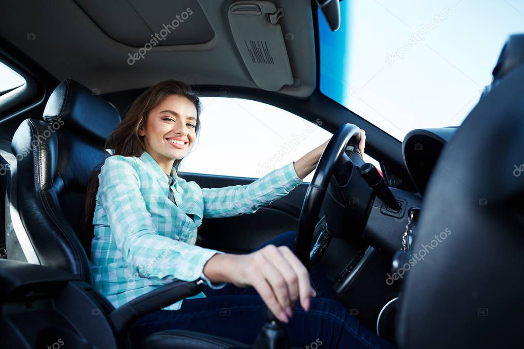 Exited woman in new automobile 