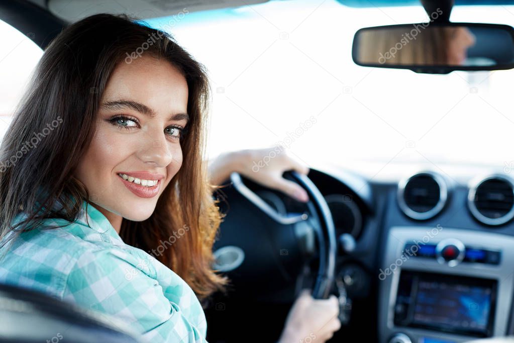 Cute woman in new automobile 