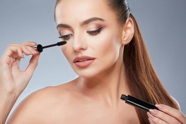 Gorgeous girl holding mascara