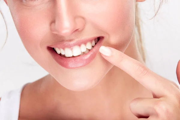 Woman points at smile — Stock Photo, Image