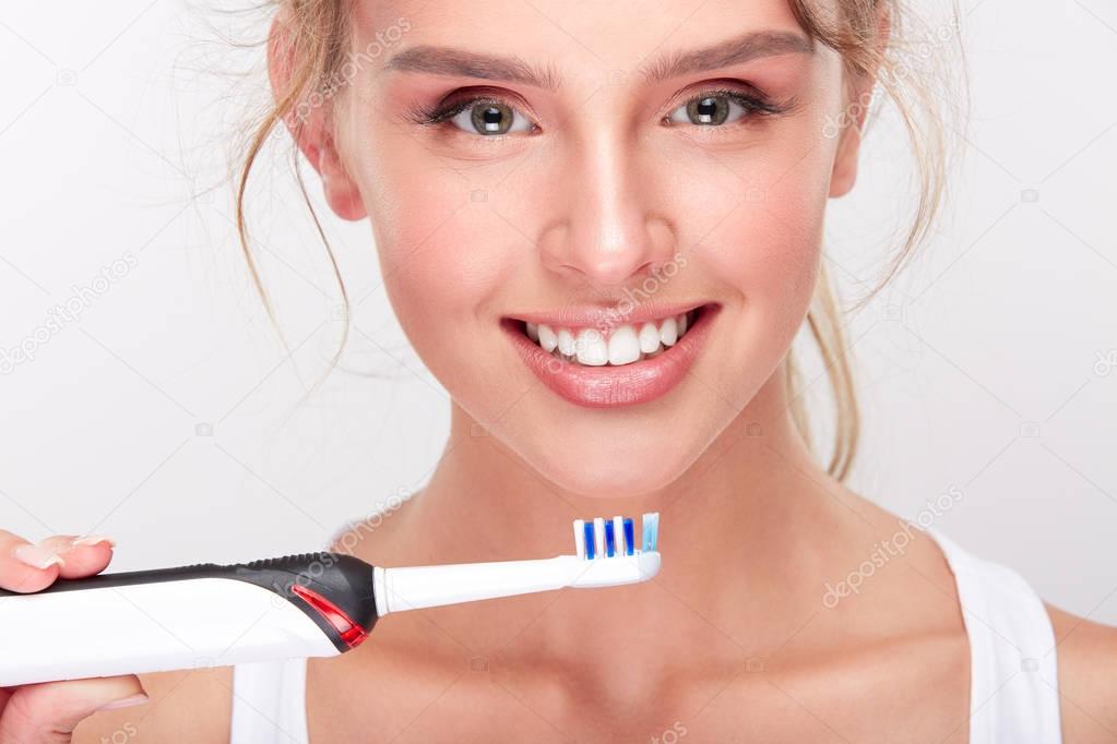 Girl holding toothbrush