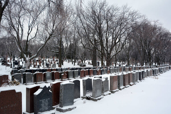 Old cemetery with snow at winter time