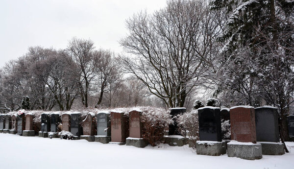 Old cemetery with snow at winter time