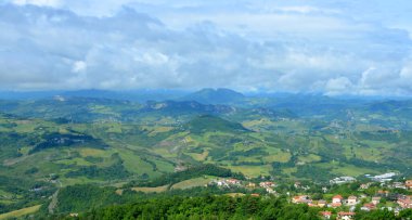 Peyzaj Dağı vadisi. Arkaplan mavi gökyüzü, beyaz yağmur bulutlarıyla dolu..
