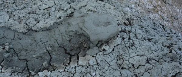 Mud Volcanoes in Gobustan near Baku Azerbaijan. A mud volcano or mud dome is a landform created by the eruption of mud or slurries, water and gases