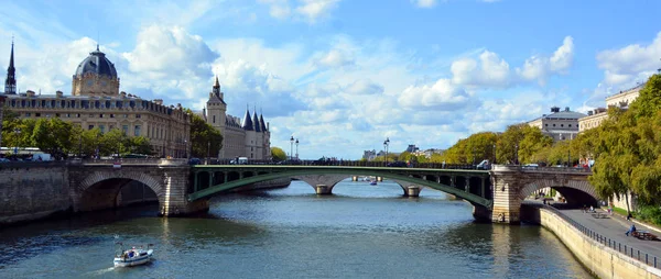 PARIS, FRANCE - JUNE 7: Seine, bridge Notre-Dame, and tourist boat, on June 7, 2009 in Paris, France. Les Halles area contains one of the largest underground modern shopping precincts in Paris.