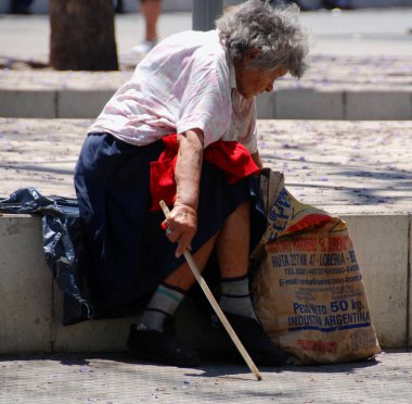 BUENOS AIRES ARGENTINA NOV 22 2011: Old homeless woman rest in park. A third of metropolitan Buenos Aires live below poverty line in Argentina has risen to its highest level in at least eight years