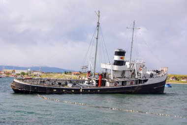 USHUAYA ARGENTINA 29 Kasım 2011 tarihinde Ushuaia, Arjantin 'de Beagle Channel körfezinde eski bir buharlı gemi. Yaygın olarak dünyanın en güneydeki şehri olarak kabul edilir..