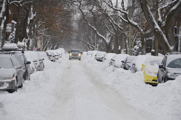 MONTREAL-CANADA DEC. 15:Cars cover of snow on Melrose Street. The snow storm slam Montreal with 35 cm of snow, Canada on Dec. 15, 2013. The winter storm, causing flight delays and traffic problems