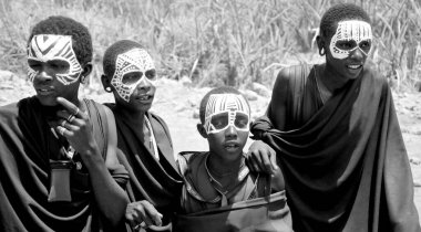 SERENGETI- TANZANIA - OCTOBER 20: Unidentified Young Masai men (Moran) wear black and markings for several months following their circumcision on October 20, 2011 Serengeti Tanzania.