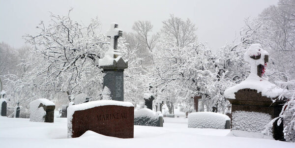 MONTREAL CANADA - 02 15 2017: During snow storm the Notre Dame Des Neiges church cemetery is a Catholic cemetery open to other faiths.