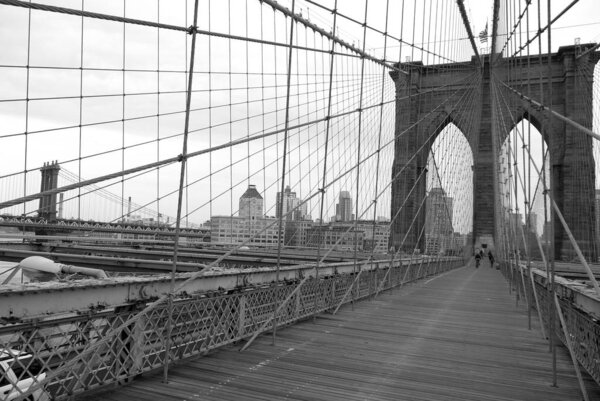 The Brooklyn Bridge is one of the oldest suspension bridges in the United States. Completed in 1883, it connects the New York City boroughs of Manhattan and Brooklyn by spanning the East River.