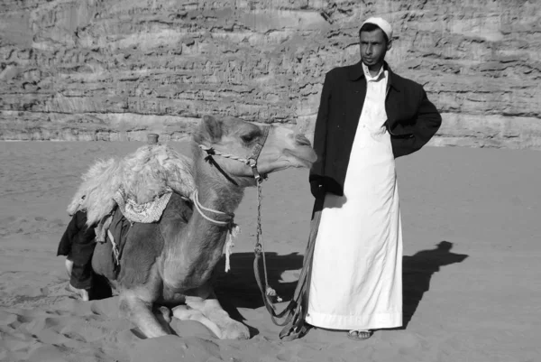 PETRA, JORDAN - NOV 25:Unidentified man waits for tourists for camel ride on Nov 25, 2009 Petra, Jordan. Ride cost 20JD. Petra was the impressive capital of the Nabataean kingdom from around the 6th century BC