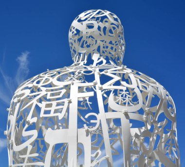MONTREAL CANADA - 05 20 2020: Source a stainless-steel sculpture consists of a random intertwining of letters taken from Latin, Greek, Chinese, Arab, Cyrillic, Hindi, Hebrew, and Japanese alphabets
