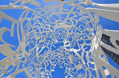 MONTREAL CANADA - 05 20 2020: Source a stainless-steel sculpture consists of a random intertwining of letters taken from Latin, Greek, Chinese, Arab, Cyrillic, Hindi, Hebrew, and Japanese alphabets