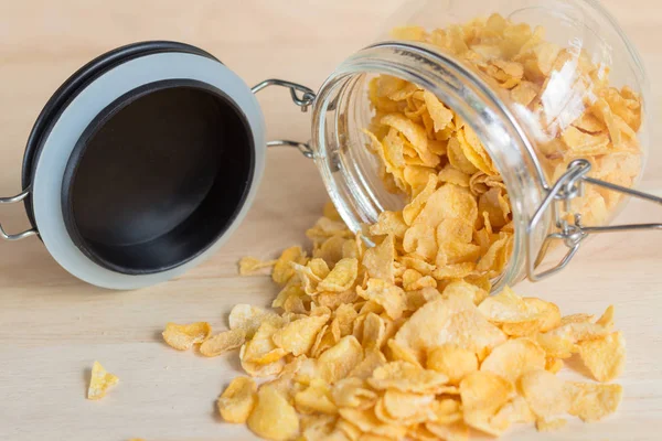 cereal cornflake spilling out from the glass jar