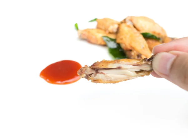 Hand holding fried chicken wings and ketchup isolated on white b — Stock Photo, Image